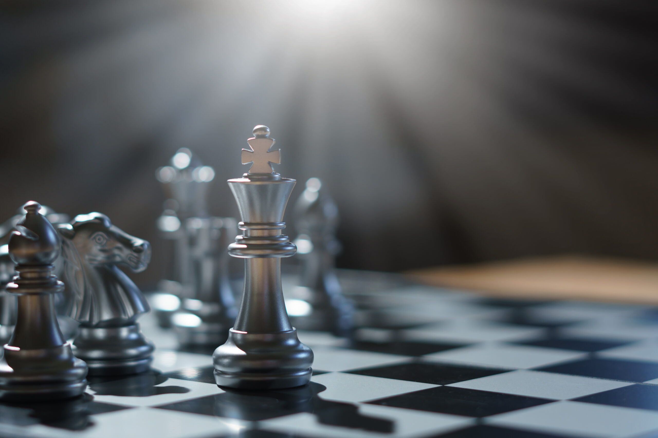 The King in battle chess game stand on chessboard  Business leader concept for market target strategy. Intelligence challenge and business competition success play.