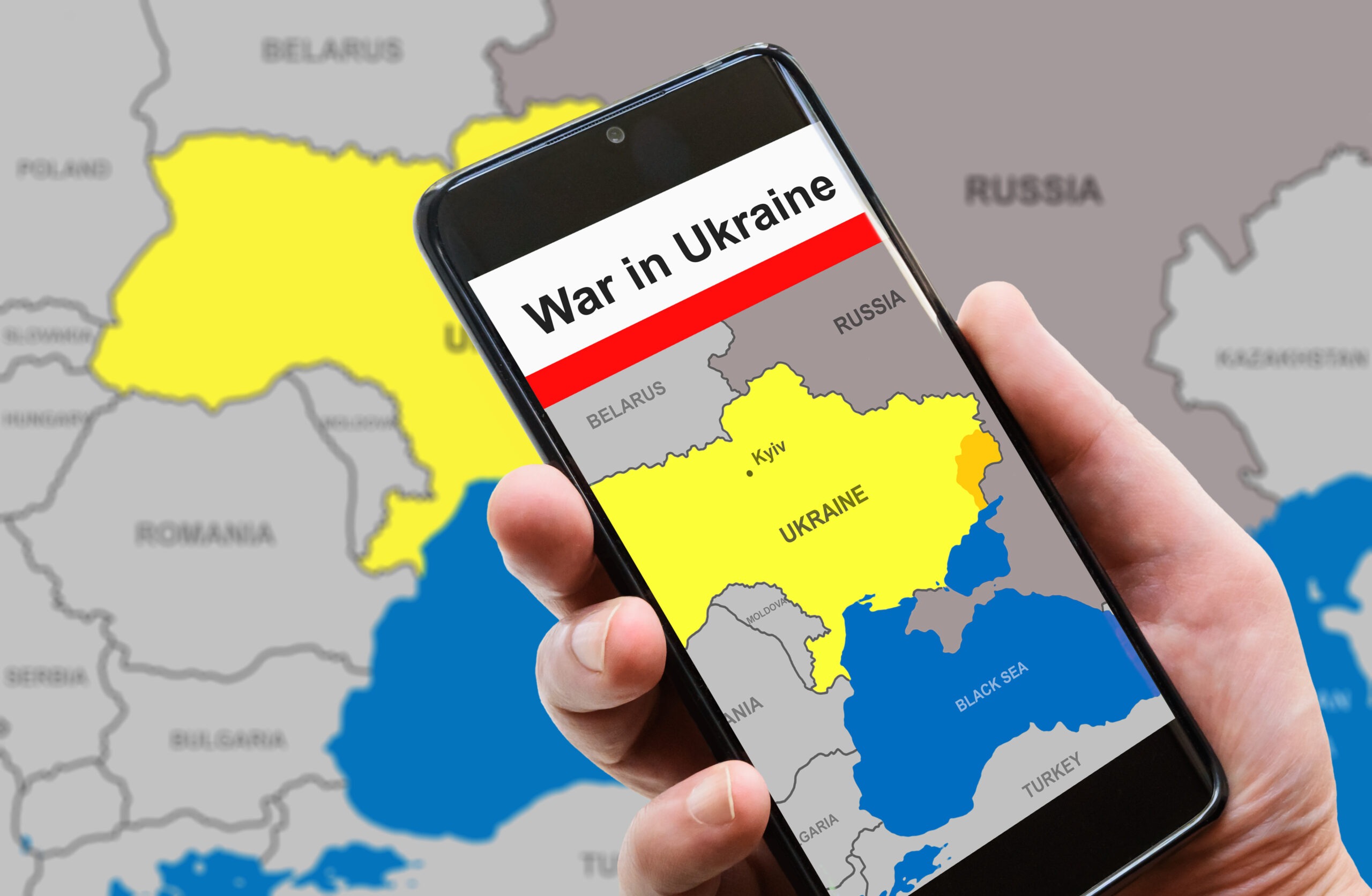 War in Ukraine on mobile phone screen. Ukraine and Russia borders with Donbass on Europe map. Ukrainian-Russian conflict in smartphone. Concept of media, news, refugees, politics and crisis.